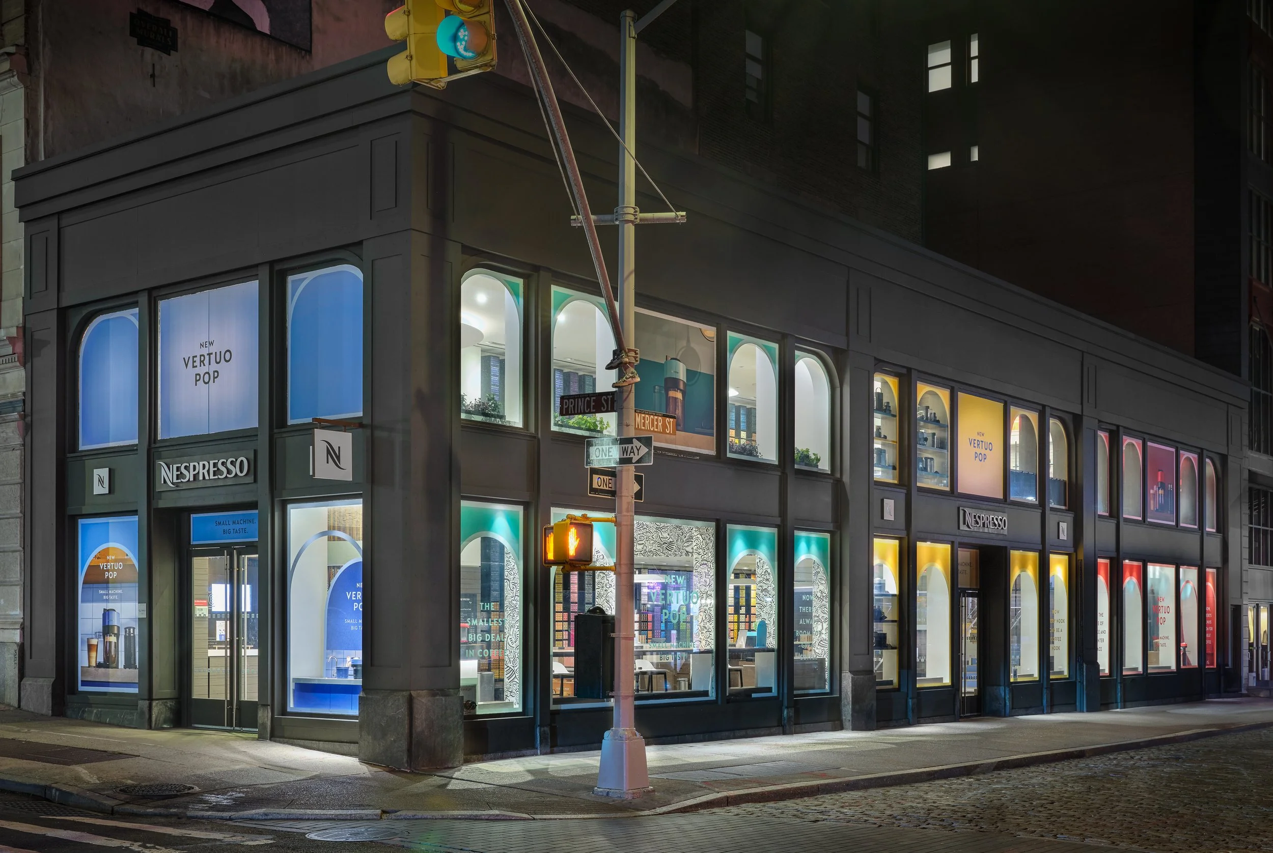 Nespresso Soho boutique at night — Vertuo Pop launch window installation with color-blocked arches