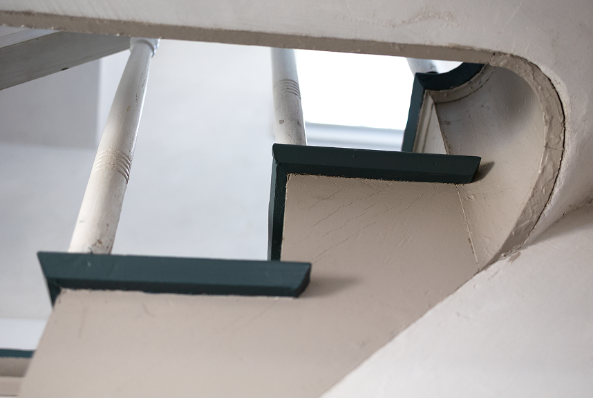 Close-up of original wooden stair treads with hand-painted dark green edges