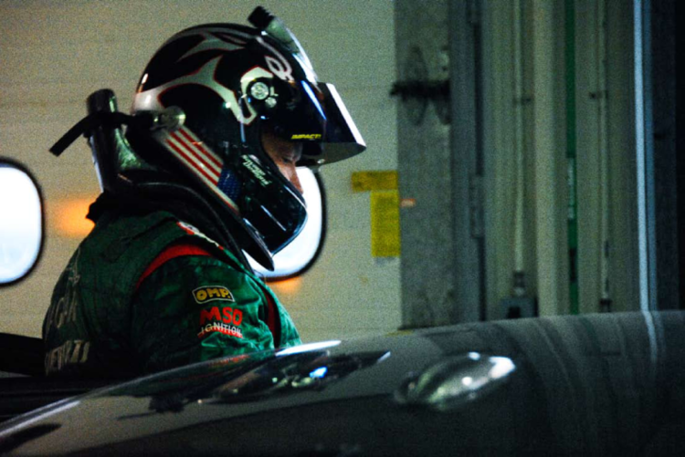 Behind the scenes at the Bonneville Salt Flats — a driver in racing gear near the XFR prototype.