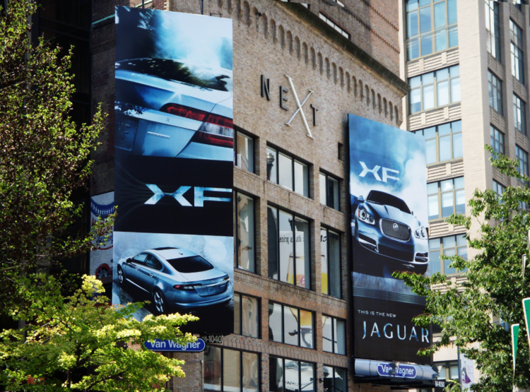Jaguar XF street-level billboards on a New York City building.
