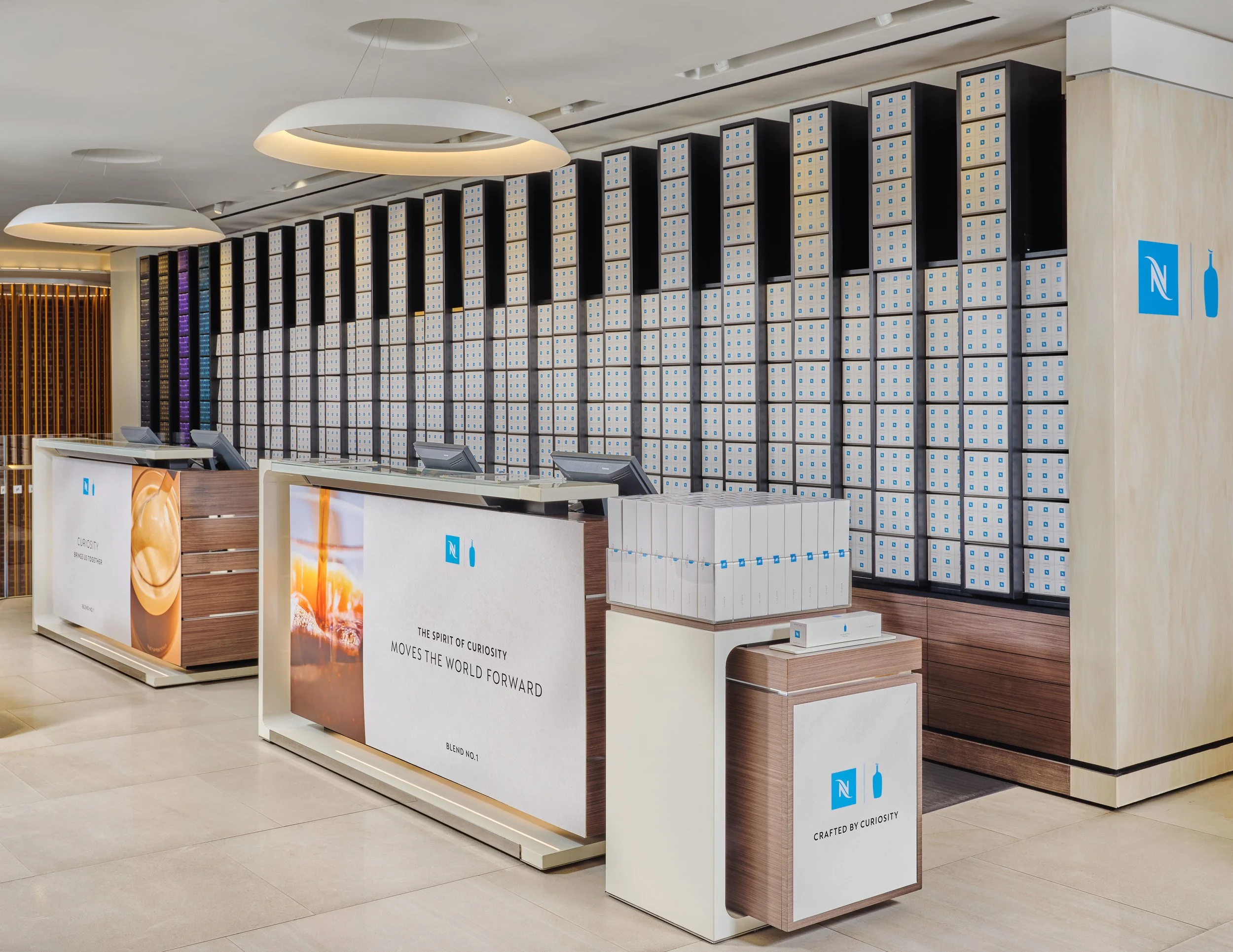 Nespresso boutique installation — illuminated brand wall